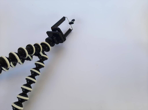 Octopus tripod or gorilla pod on isolated white background. Flexible folding tripod for mobile phones. - Foto, Bild