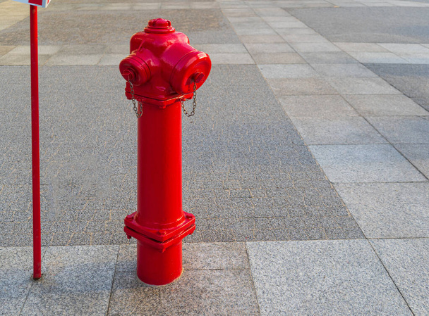A Fire Hydrant, Waterplug, or Firecock on City Street, Red Steel Pipe to Extinguish Fires, Urban Fire-Fighting Equipment - Foto, Imagen