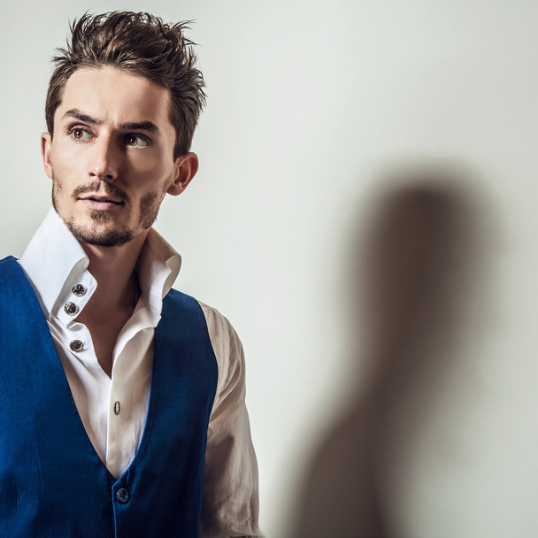 Elegant young handsome man in white shirt & vest. Studio fashion portrait. - Fotoğraf, Görsel