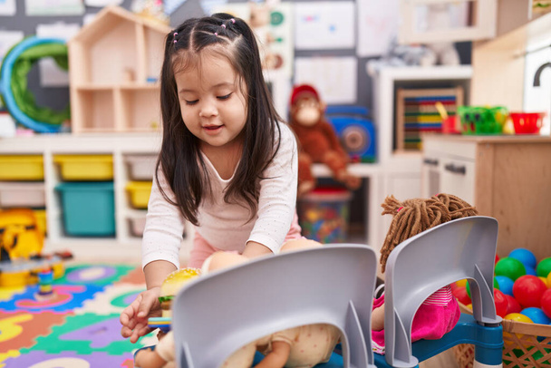 Adorable hispanic toddler playing with play kitchen and toys at kindergarten - Photo, Image