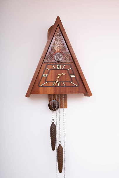 Vintage cuckoo clock isolated for creative background.cuckoo clock hanging on the wall. - Φωτογραφία, εικόνα