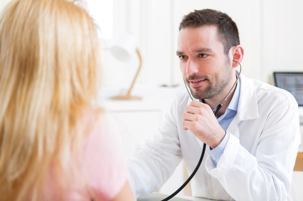 Young attractive man listenning in his stethoscope - Photo, Image