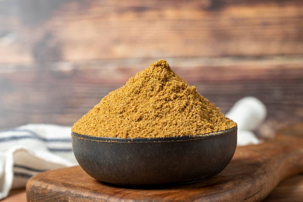 Powdered cumin spice. Cumin spice in bowl on wooden background. Dry spice concept. close up - 写真・画像