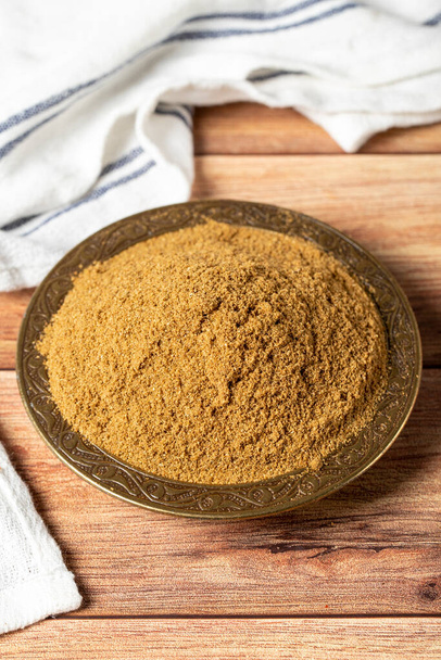 Powdered cumin spice. Cumin spice in bowl on wooden background. Dry spice concept. close up - Foto, Imagem