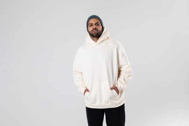 African American man in a knitted hat and white oversized hoodie. Mock-up. - Foto, immagini