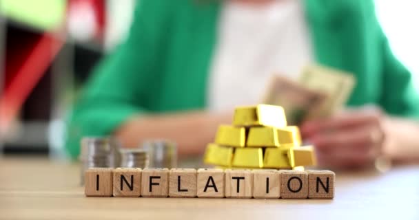 Inflation stacks of gold bars businesswoman considers declining income dollars. Reducing price of gold in trading commodities in investment market - 映像、動画