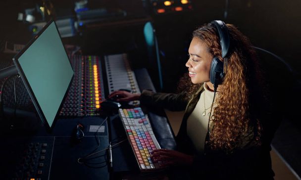 Woman, smile or musician headphones in computer music recording, sound engineering or song composition in studio. Producer, happy or DJ on technology in live streaming radio, edm audio or media album. - Φωτογραφία, εικόνα