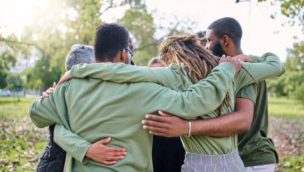 Group hug, support and people in park for eco friendly, sustainable or community service project, teamwork or love. Together, circle and diversity, inclusion friend in forest or nature for earth day. - Foto, Bild