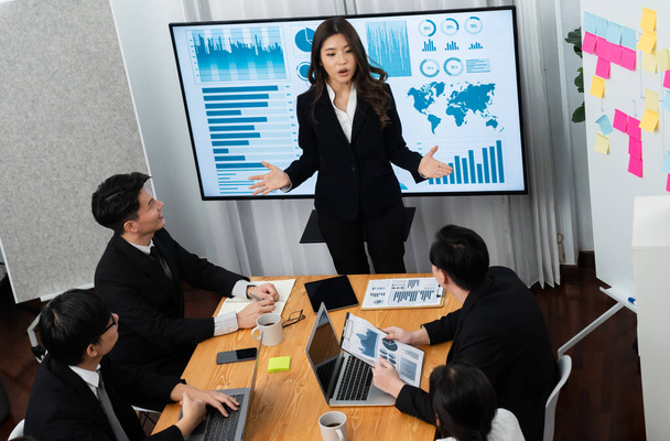Top widen view of confidence of company presentation on financial analyzed by business intelligence in dashboard report with businesspeople in boardroom meeting to promote harmony in workplace concept - 写真・画像