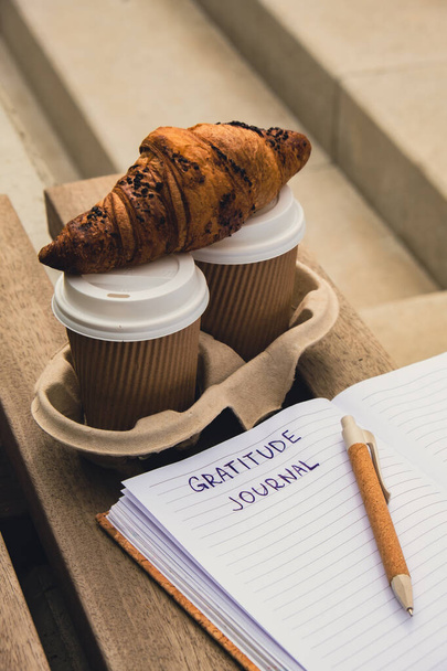 Writing Gratitude Journal on wooden bench. Coffee and croissants morning routine. Today I am grateful for. Self discovery journal, self reflection creative writing, self growth personal development - Photo, Image