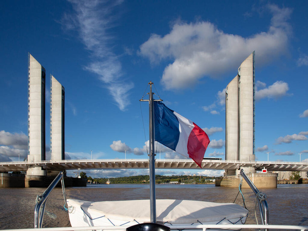 lift modern bridge with french boat flag in Bordeaux city architectural feat the Jacques Chaban-Delmas bridge - Zdjęcie, obraz