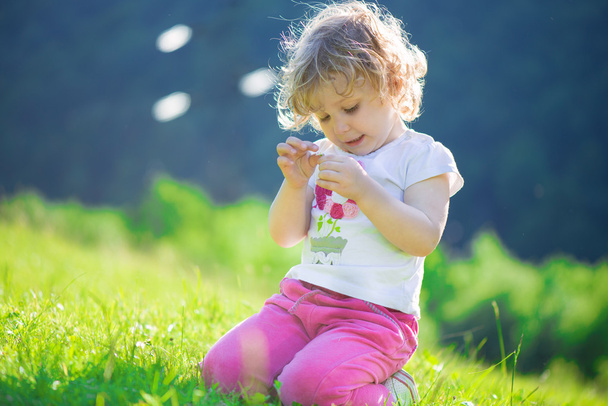 Cute little girl at sunny meadow - Photo, Image
