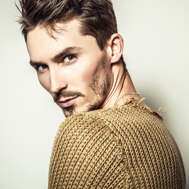Studio portrait of young handsome man in knitted sweater. Close-up photo. - Foto, imagen