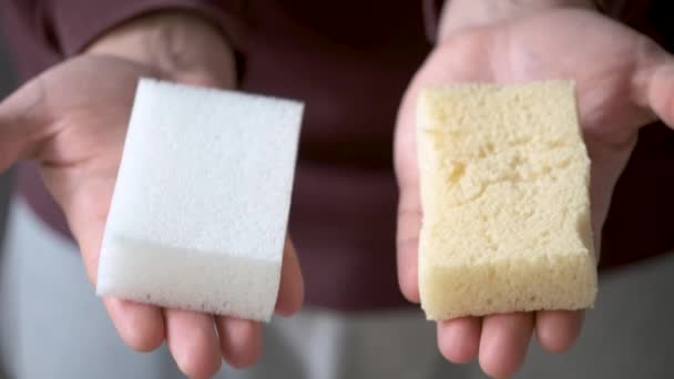 Mens hands comparing new and old bath sponge. - Footage, Video