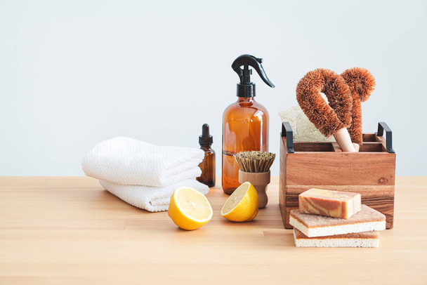 Zero waste eco friendly products and tools for kitchen cleaning. Wooden brushes, coconut sponges, spray vinegar, lemon and organic soap, gray background. - Foto, imagen