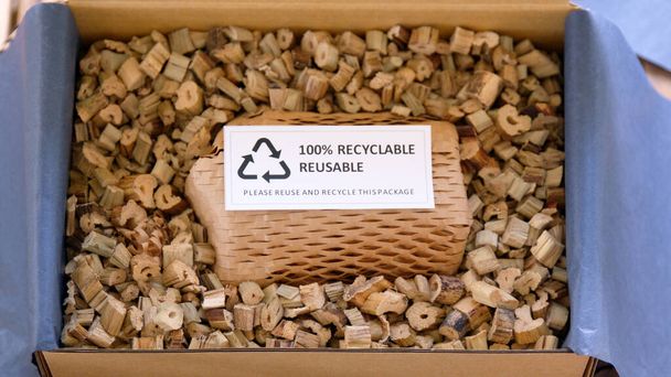 Net zero waste go green SME use eco friendly care sign plastic free symbol packaging carton box wrap paper in small shop retail store. Chva dried water hyacinth on desk reuse packing parcel supplies. - Fotografie, Obrázek