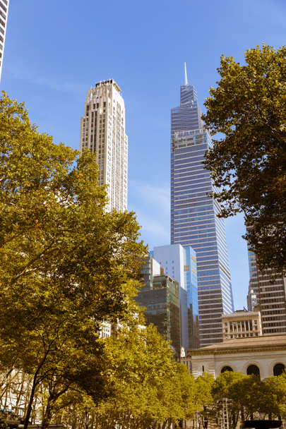 Rockefeller Plaza and Central Park towers near autumn trees on urban street in New York City - Foto, Imagem