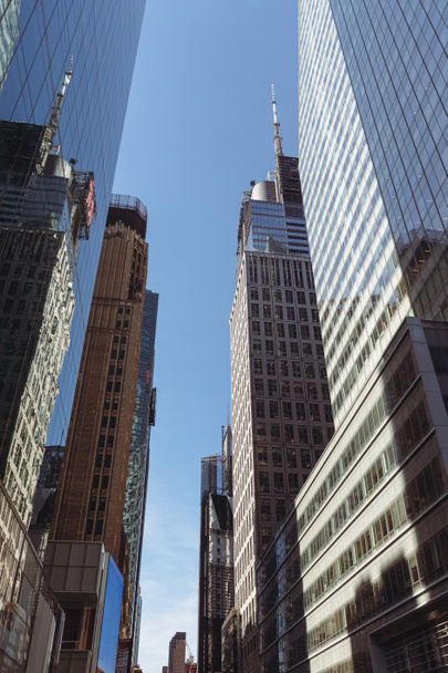 low angle view of modern skyscrapers against blue sky in financial district of New York City - Foto, Bild