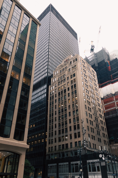 low angle view of concrete and glass buildings in midtown of New York City - Fotó, kép