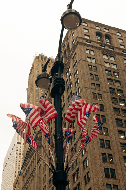 low angle view of usa flags on street lantern in New York City - Photo, image