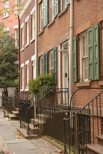 brick dwelling house with metal railings near entrances on street of New York City - Фото, зображення