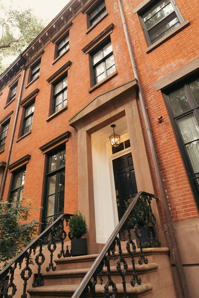 low angle view of brick house with lantern above entrance in Brooklyn Heights district of New York City - 写真・画像