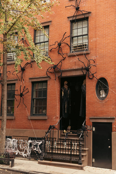 Halloween decoration on brick facade of building on street in New York City - Foto, afbeelding