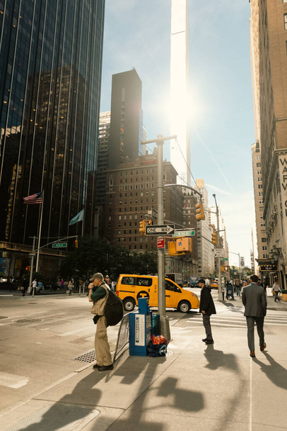 NEW YORK, USA - OCTOBER 11, 2022: People on sidewalk near road on urban street in Manhattan  - Fotó, kép