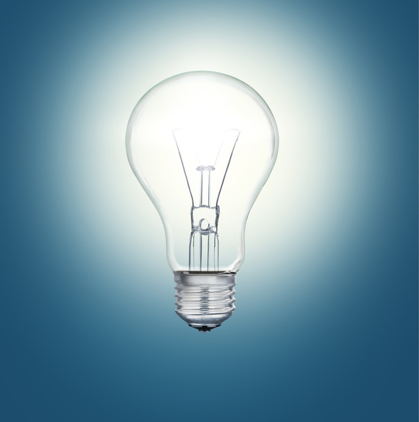 A light bulb shines in the darkness bright light - Фото, зображення
