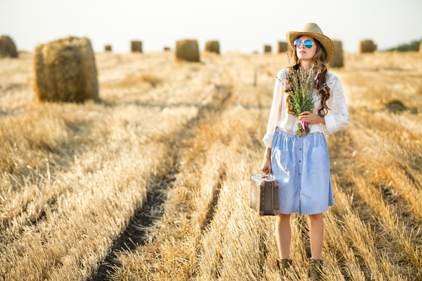 Young beautiful woman in summer field - Фото, изображение