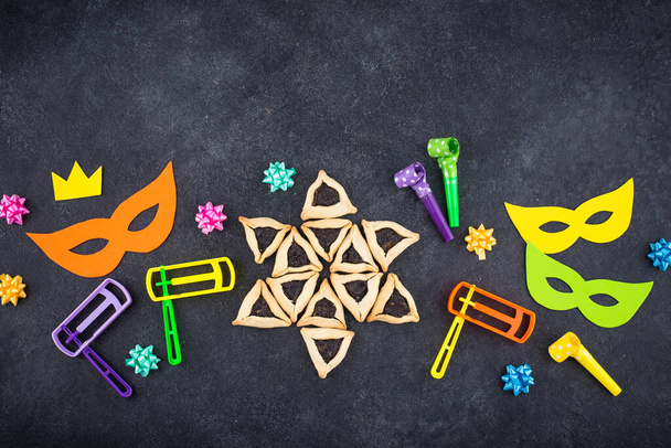 Jewish holiday Purim with carnival mask, traditional cookies Hamantaschen and rattle - Φωτογραφία, εικόνα