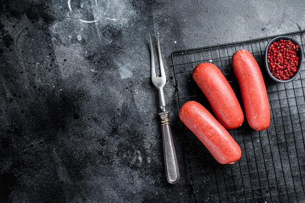 Turkish Sucuk beef meat sausage. Black background. Top view. Copy space. - 写真・画像