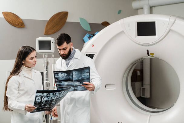 CT rentgen rakoviny plic na lékařské klinice. Kolegové lékaři s rentgenem počítačové tomografie skenování diskutovat diagnózu rakoviny plic na lékařské klinice - Fotografie, Obrázek