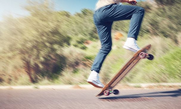 Sports, skill and man on a skateboard in the road for an outdoor hobby, training or exercise. Gen z, blur motion and male skater or athlete skating in the street for a fitness workout in nature - Foto, Imagen