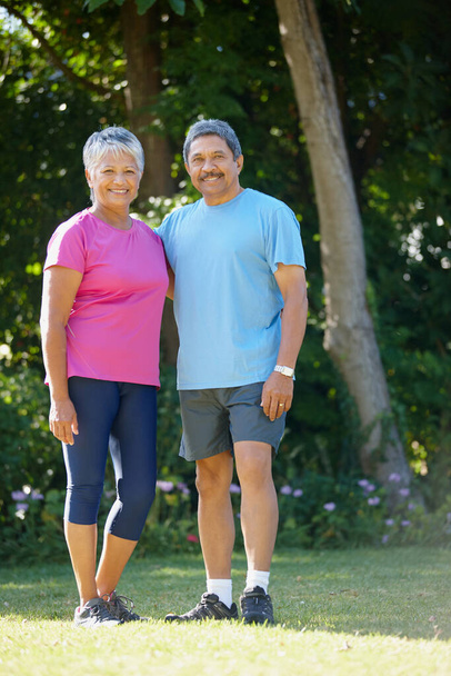Keeping active and healthy. Portrait of a mature husband and wife exercising together - Photo, Image