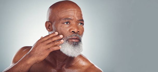 Skincare, grooming and face of black man for wellness, haircare and healthy skin on gray background. Beauty mockup, advertising and senior male pose for beard care, facial treatment and dermatology. - Фото, зображення