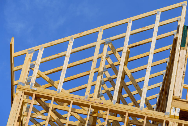 wood frame residential building under construction building construction wood framing structure at new property development plywood blue tall - Foto, imagen