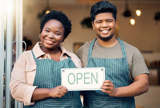 Portrait, couple and open sign by small business owners happy at coffee shop, cafe and support together. Team, restaurant and black people smiling due to startup growth and proud of success or vision. - Foto, Bild