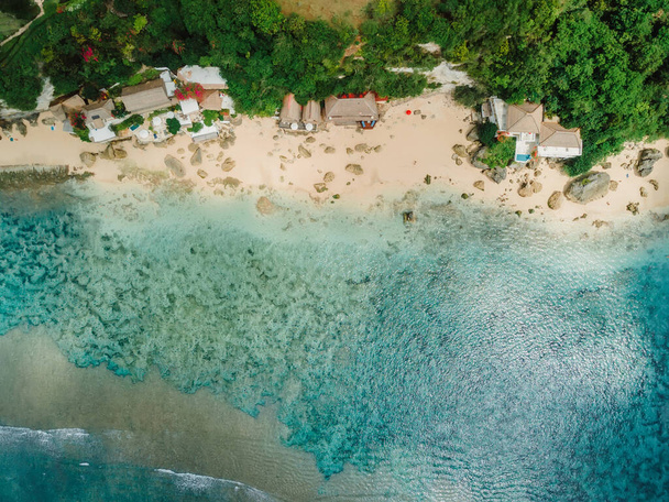 Aerial view of blue ocean and coastline with cozy hotels on Impossibles beach in Bali island - Фото, изображение
