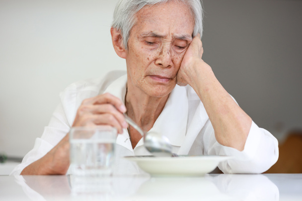 Sick asian senior woman suffering from anorexia,bored with meal,eating less food,discomfort in swallowing,disease of Dysphagia,Old elderly patient with Anorexia-Cachexia syndrome,lack of appetite - Valokuva, kuva