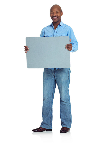Information worth noticing. Studio shot of an african man holding up a blank board against a white background - Foto, Bild
