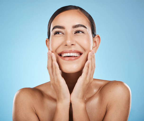 Face, beauty and skincare of woman in studio isolated on a blue background. Aesthetics, makeup and cosmetics of happy female model with healthy, glowing and flawless skin after spa facial treatment - Photo, Image