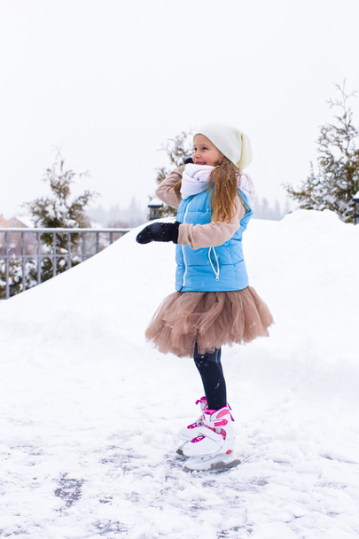Happy adorable girl playing snowballs in snowy winter day - Photo, Image