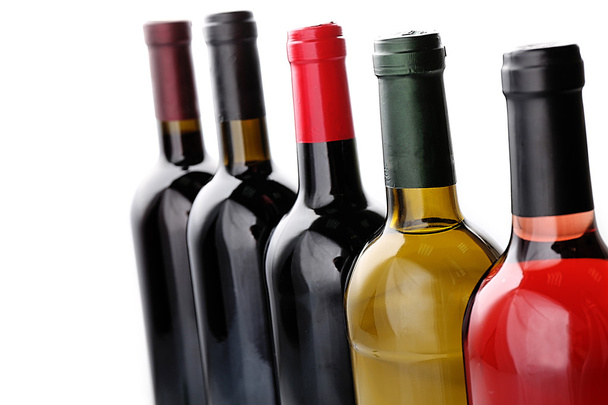 Wine bottles in row isolated on white - Fotó, kép