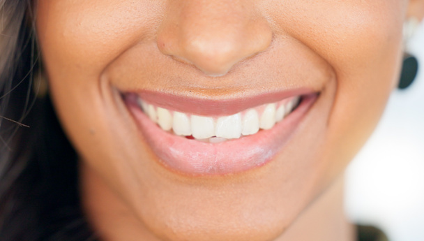 Smiling, beautiful and fresh female face winking feeling fun, silly and playful. Portrait of a happy woman head with perfect skin and healthy teeth. Closeup of a carefree natural beauty with a smile. - Foto, afbeelding