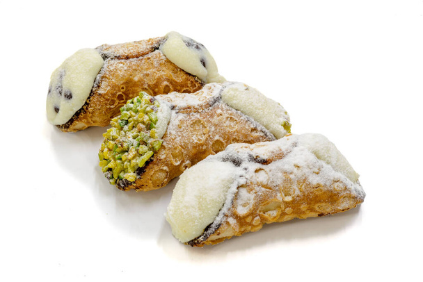 three sicilian cannoli with different tastes, isolated on white background with shadow - Foto, Bild