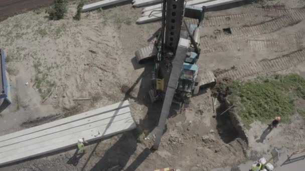 Pile driving machine driving piles into ground site. Modern hydraulic lifting mechanisms. Ukraine.  - Video