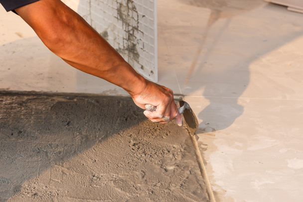 Labor installing tile floor - Photo, Image