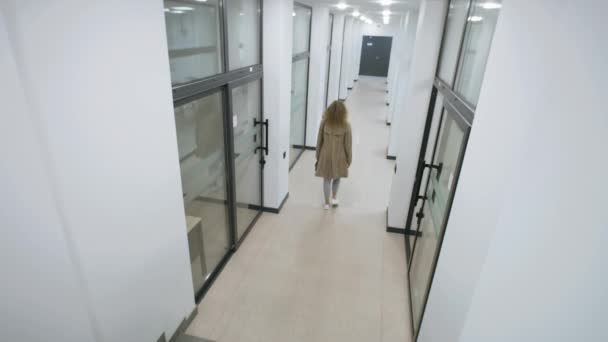 View from security cameras in business center. Woman and two men walk in corridor. Workers walking in hallway of office. Concept of tracking system, monitoring and safety. Security camera shooting. - Séquence, vidéo