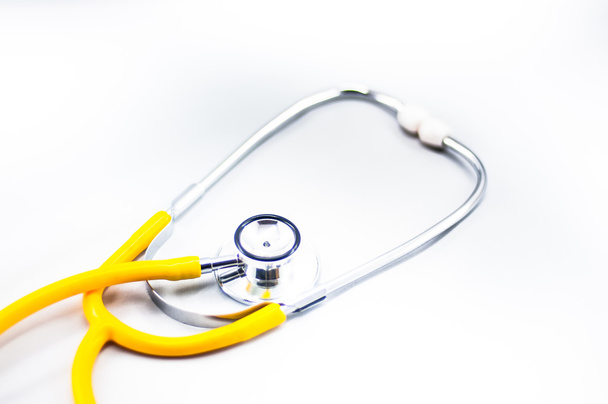 Yellow stethoscope with white background - Foto, imagen
